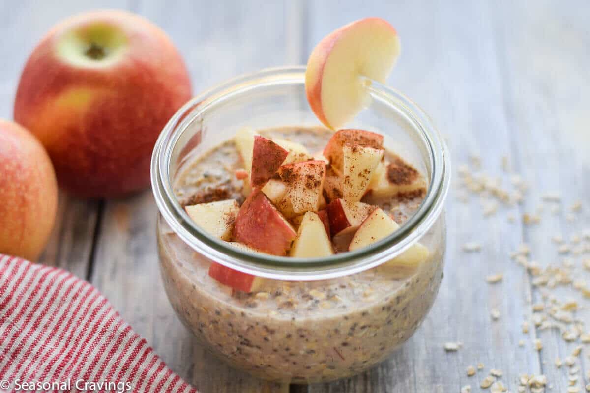 Overnight oats in a jar topped with chopped up apple slices.