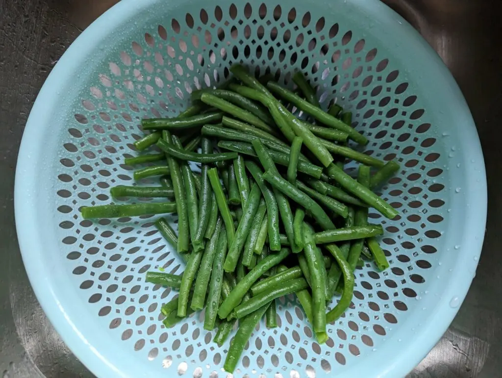 Green beans draining in a colander.