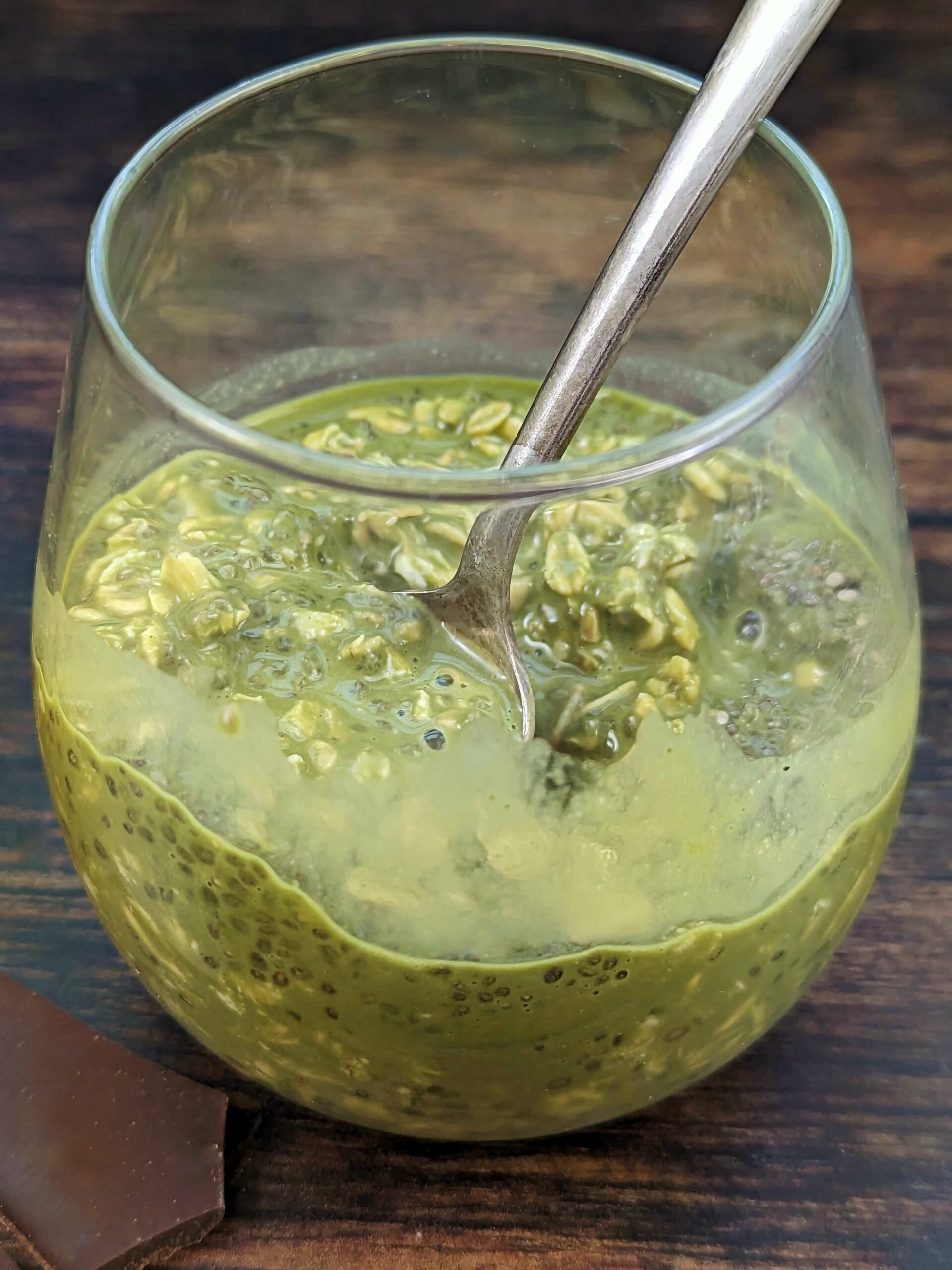 Matcha overnight oats with a spoon in it.