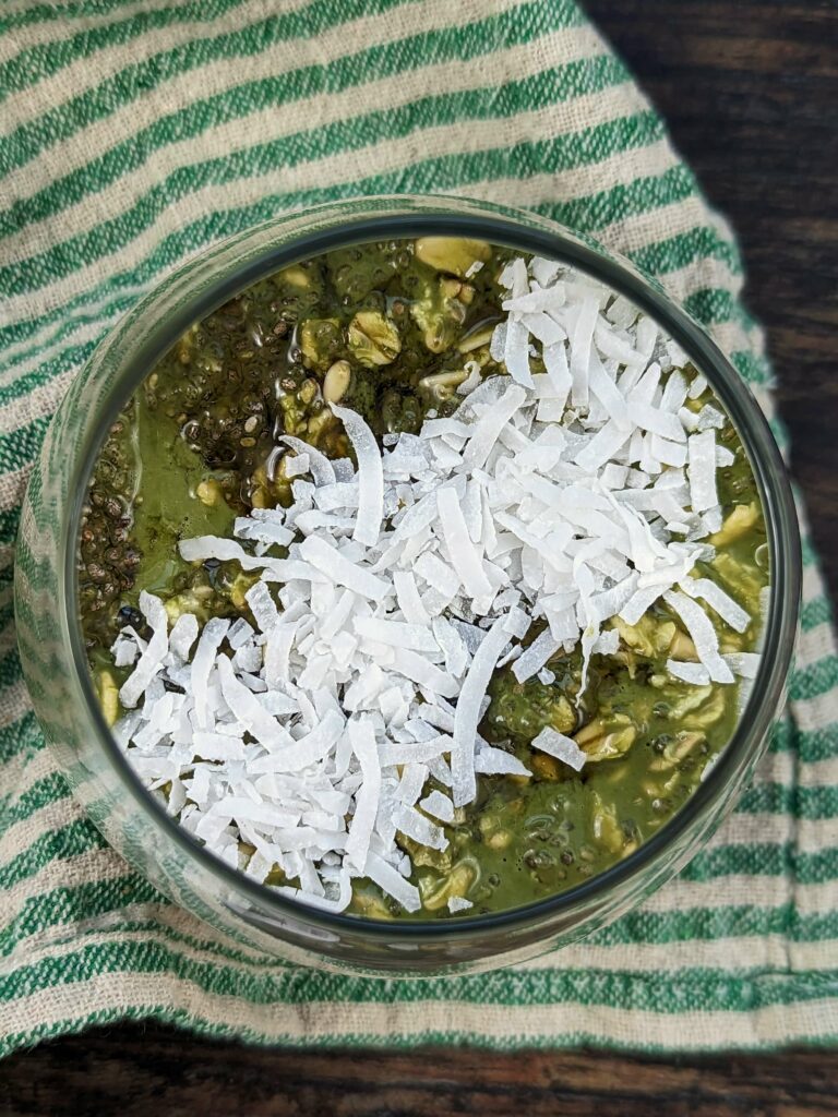 Matcha overnight oats topped with coconut flakes.