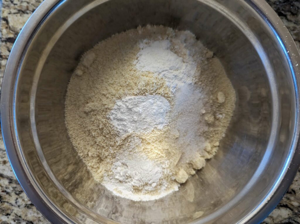 Dry ingredients for oat milk pancakes in a mixing bowl. 