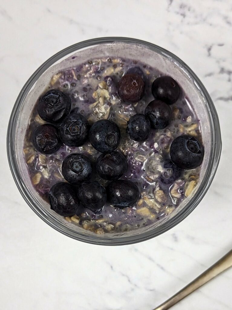 Overnight oats with frozen fruit and topped with fresh blueberries.