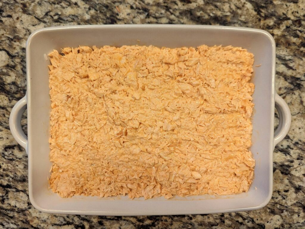 Rice and salmon in a baking dish.