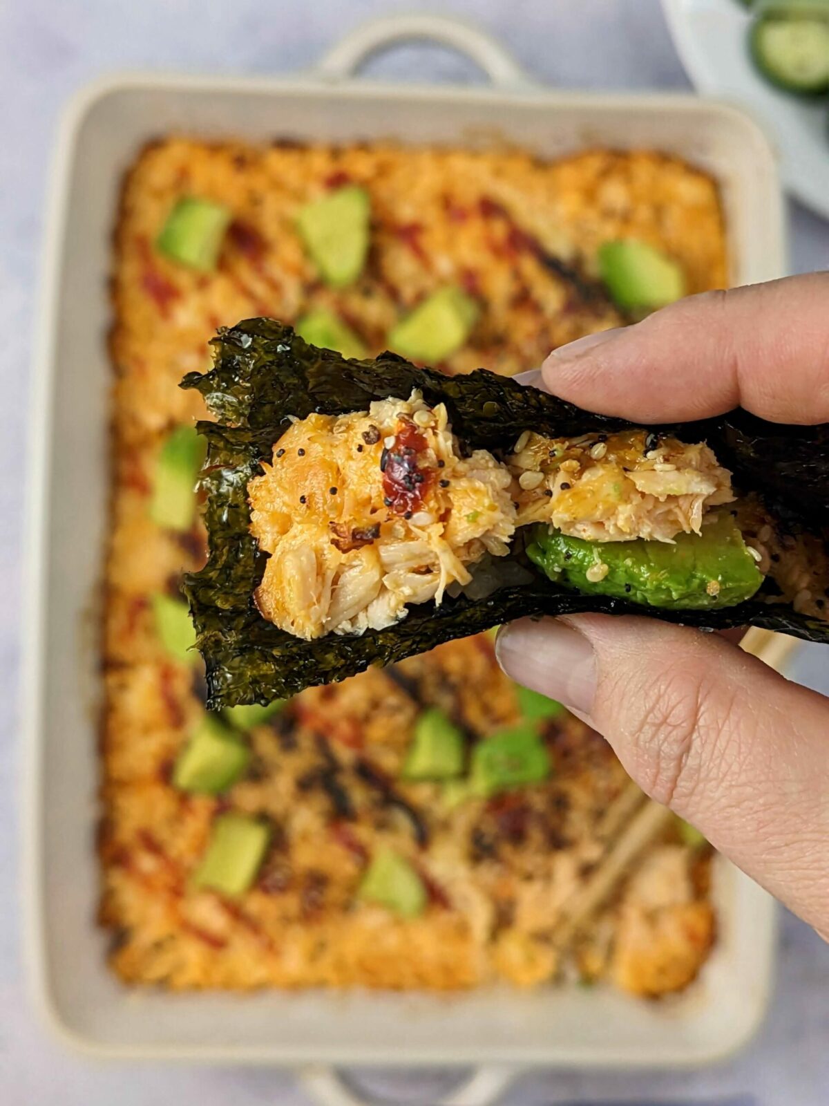 Our salmon sushi bake recipe topped with diced avocado and furikake.