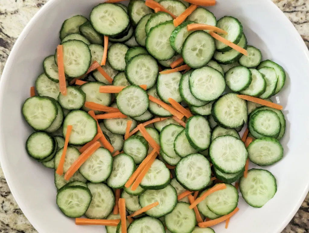 Cucumbers and carrots in a bowl.