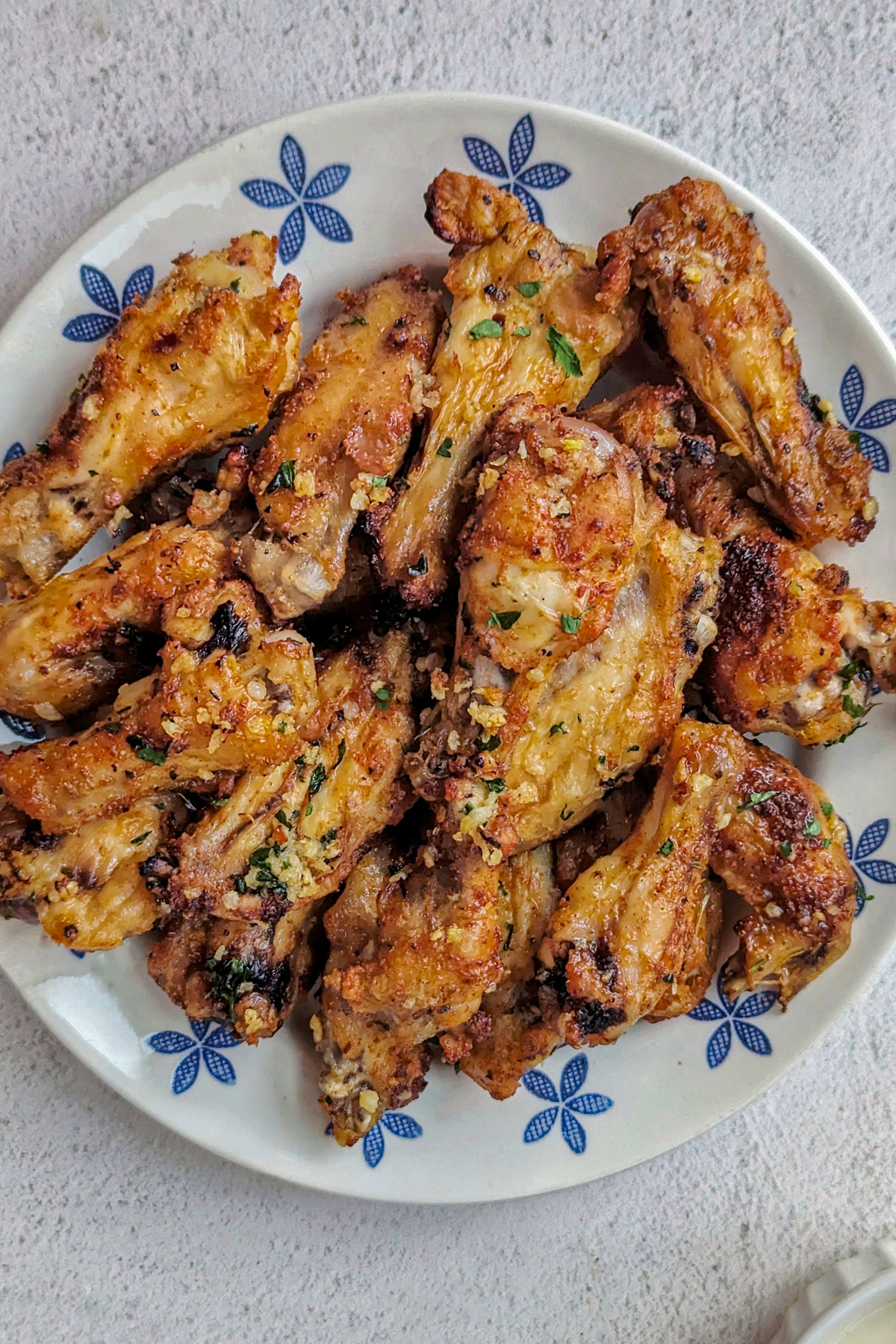 Garlic butter chicken wings on a plate.