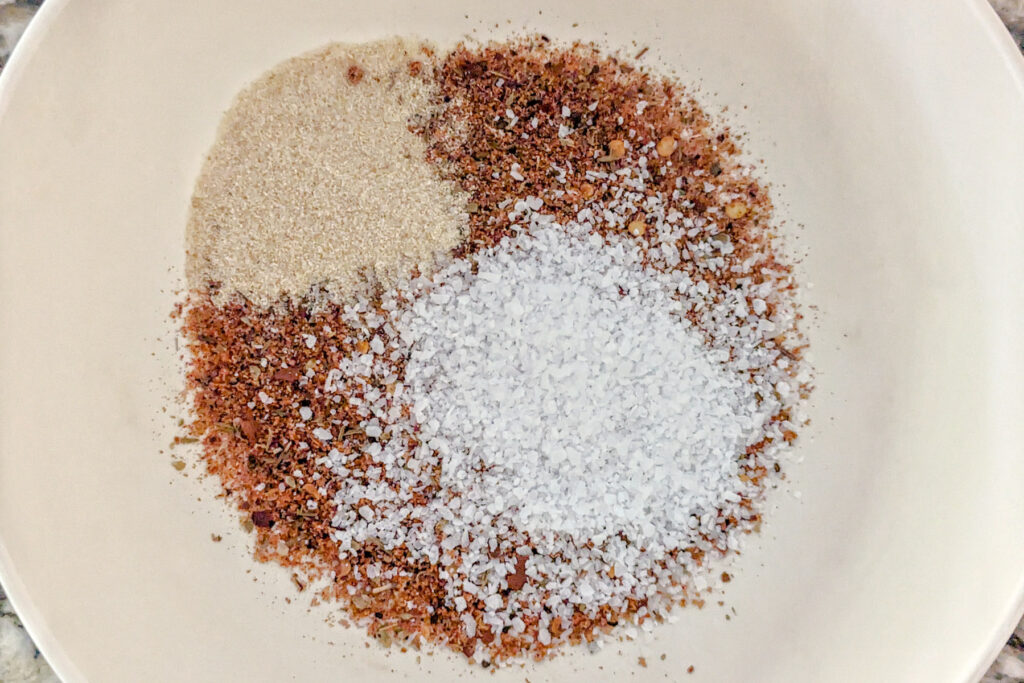 Spices and baking soda for the wings in a small bowl.