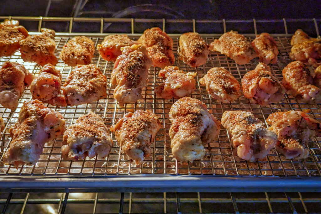 Chicken wings baking in the oven.