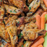 Garlic butter chicken wings in a serving dish.
