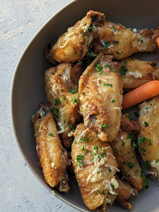 Garlic Parmesan Wings Air Fryer Recipe on a plate with carrots.