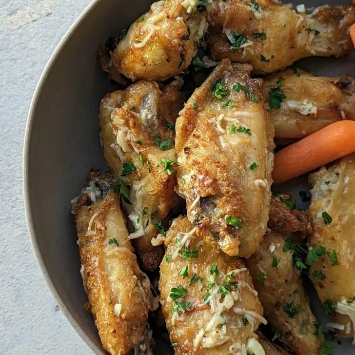 Air Fryer Garlic Parmesan Wings on a plate with carrots.