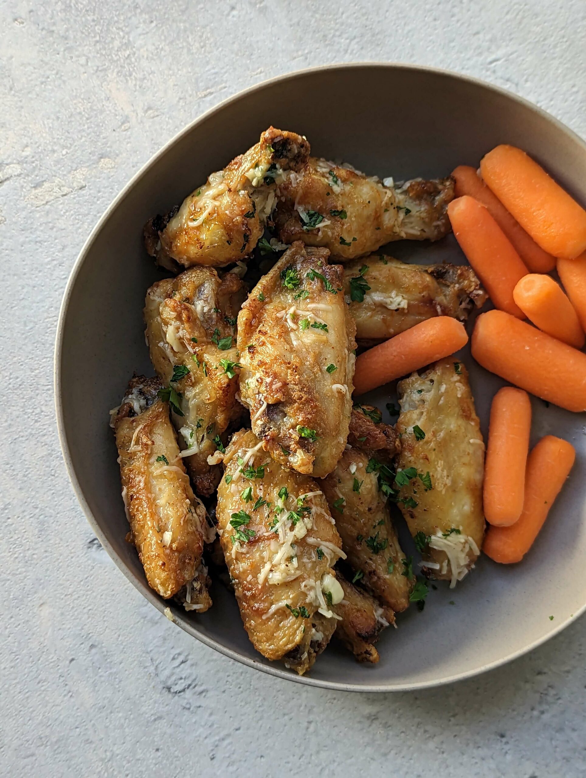 Garlic Parmesan Wings Air Fryer Recipe on a plate with carrots.