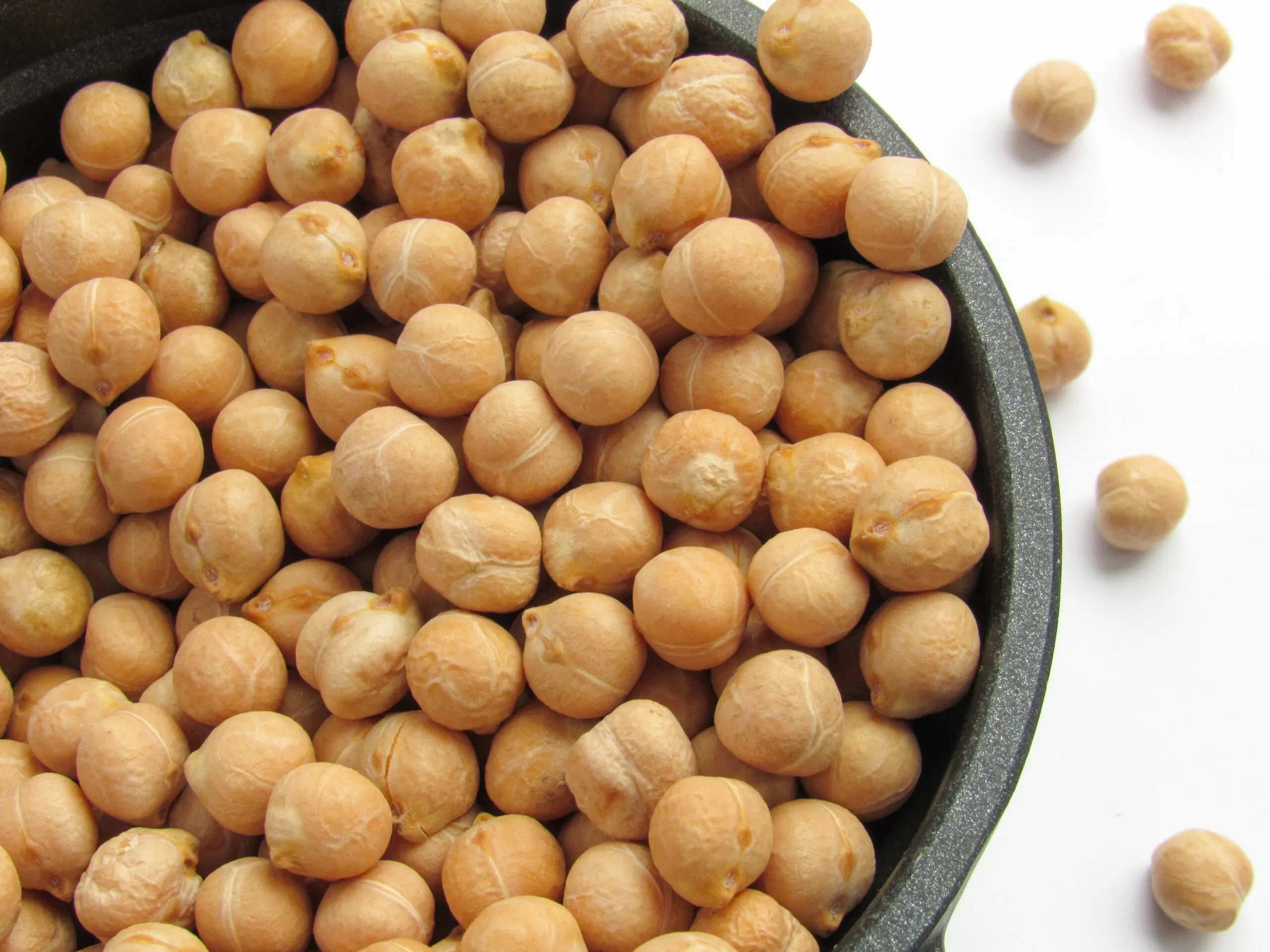 A close up of chickpeas in a bowl.