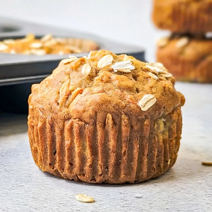 Banana carrot muffins on a surface.