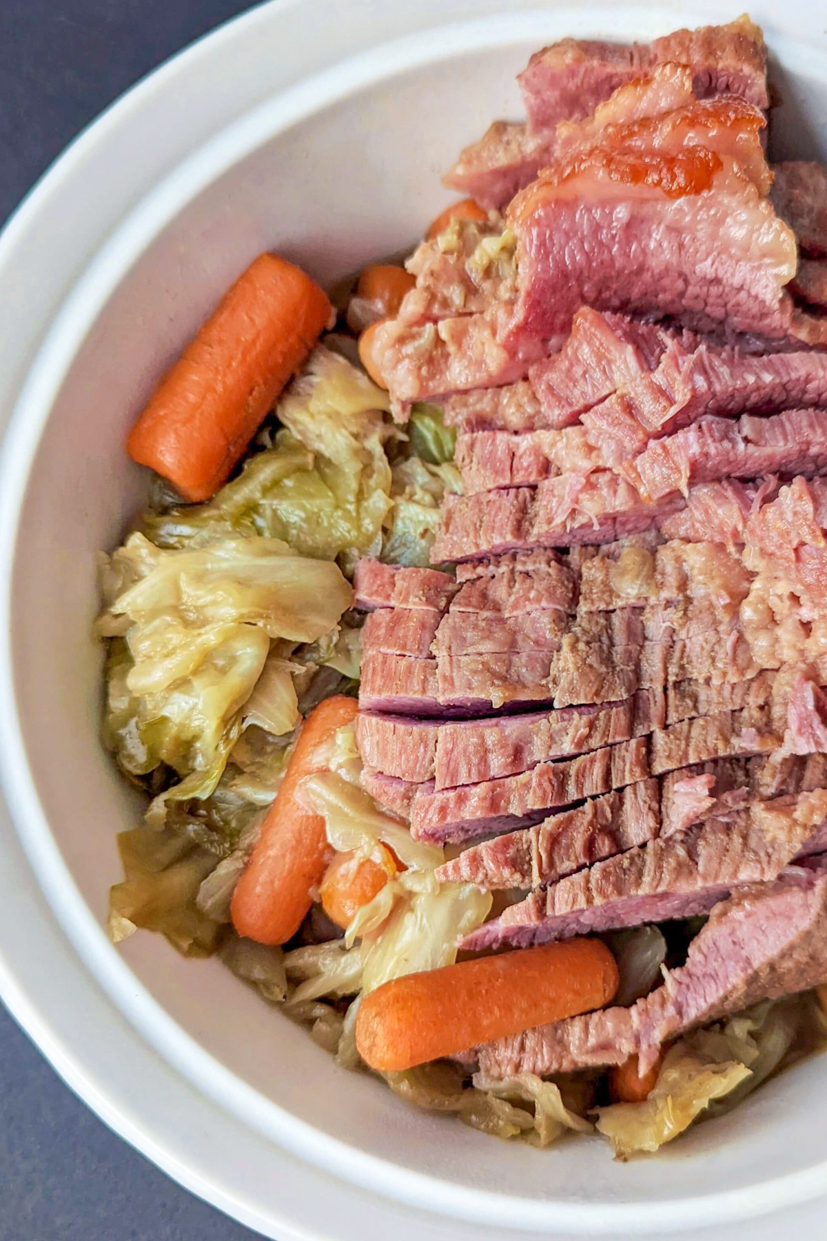 Dutch Oven Corned Beef and Cabbage in a serving dish.