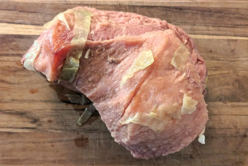 Corned beef brisket on a cutting board.