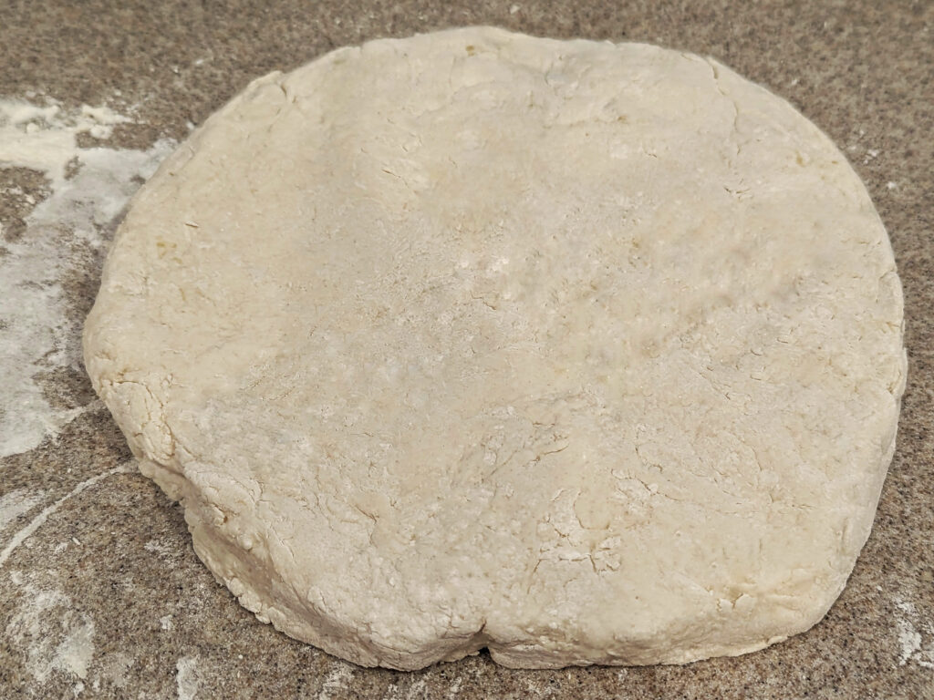 Soda bread dough formed into a disc.