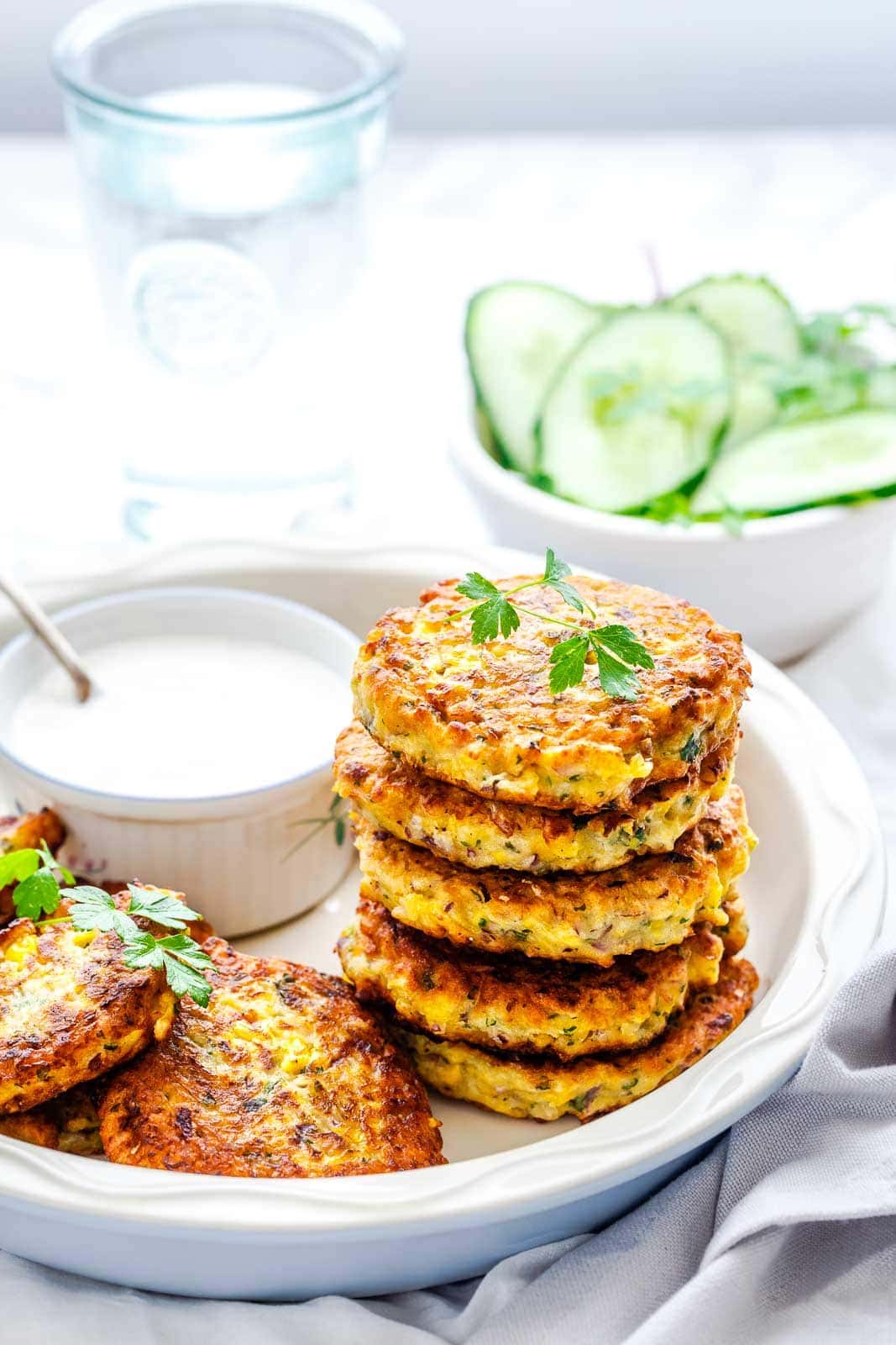 A stack of corn fritters on a plate.