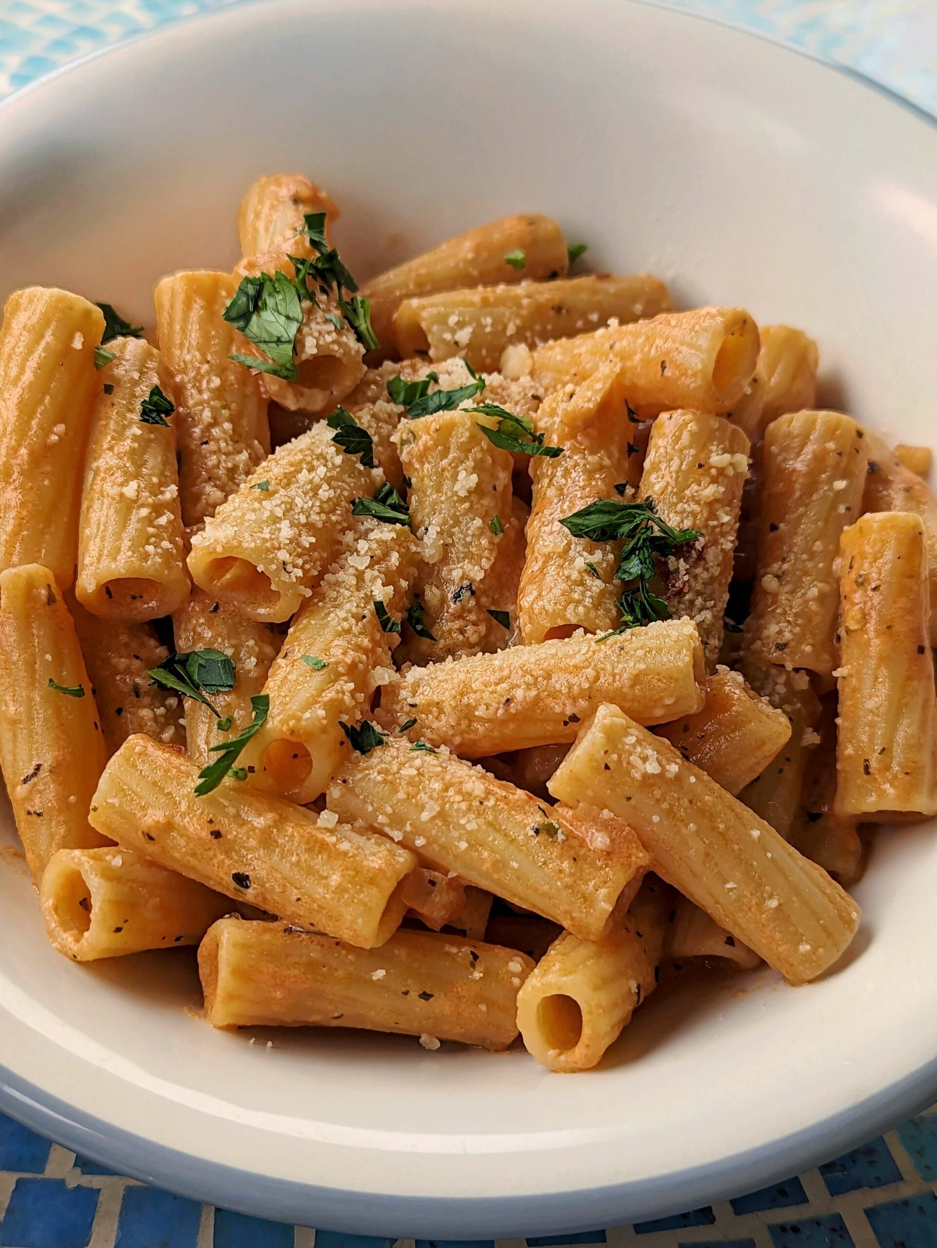 Gigi hadid pasta recipe in a serving bowl topped with parsley.