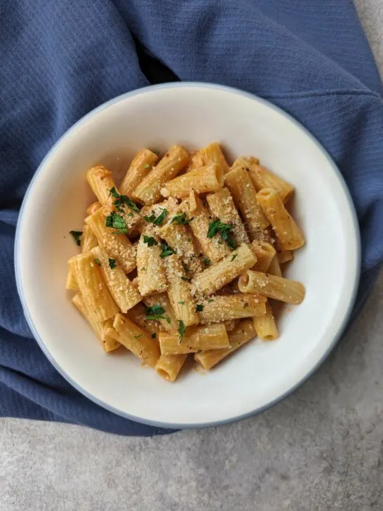 Gigi hadid pasta recipe in a serving bowl topped with parsley.