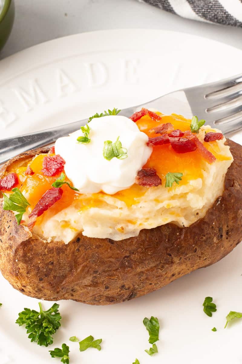 A twice baked potato topped with sour cream.