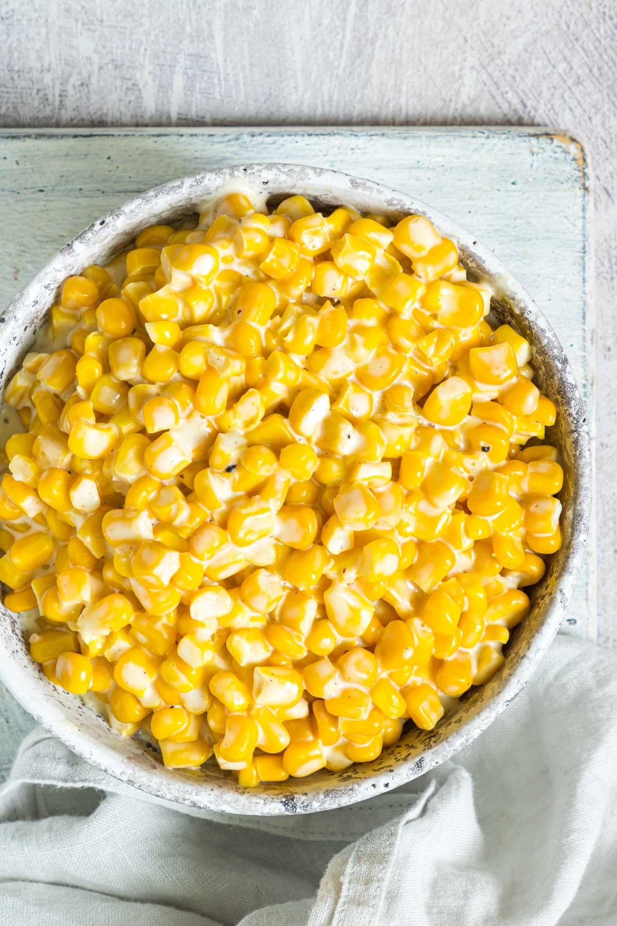 A close up of creamed corn in a serving bowl.