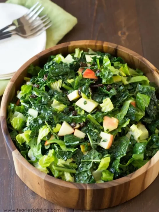 Kale salad with apple in a serving bowl.