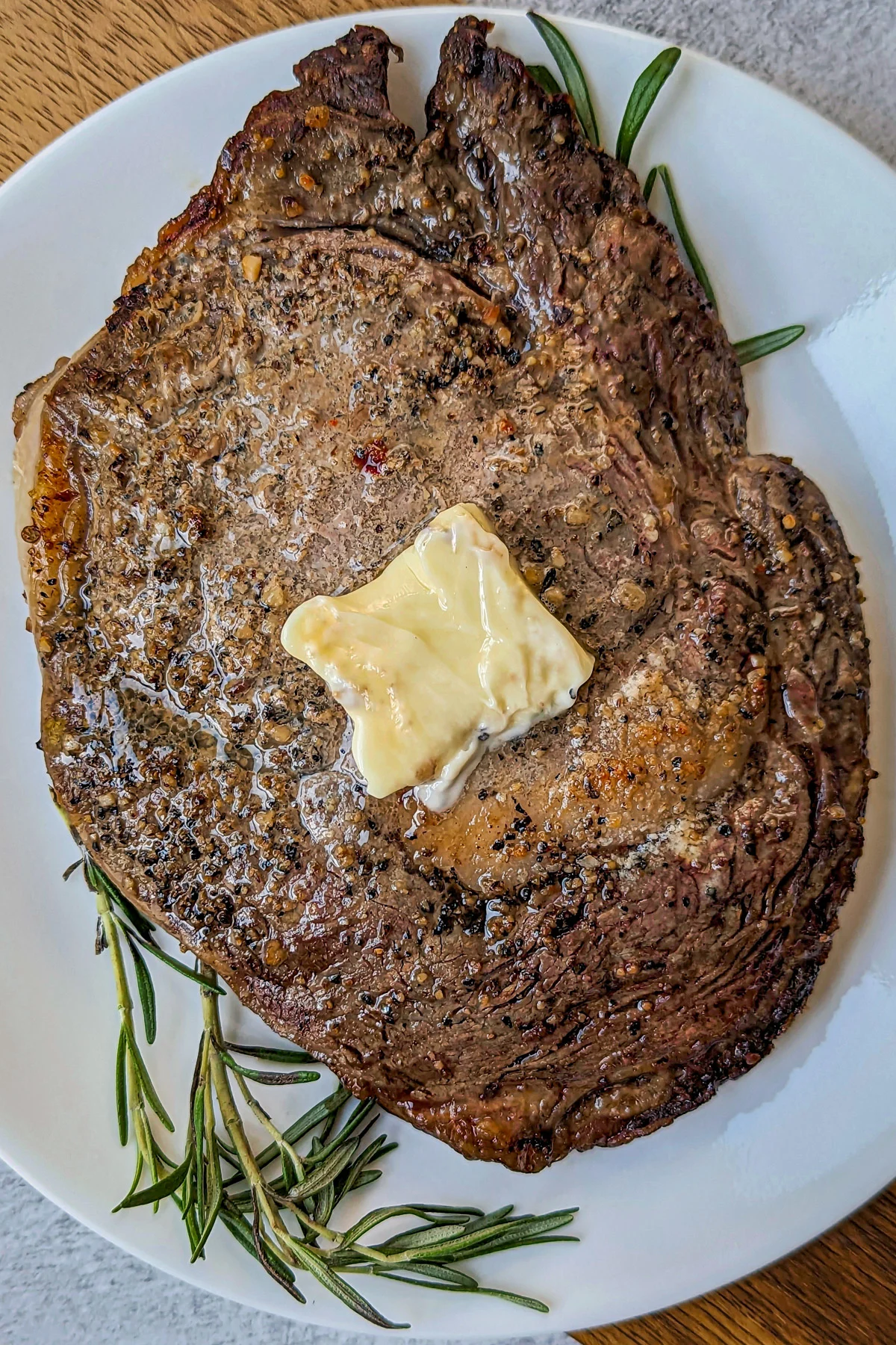 A air fryer ribeye steak on a plate.