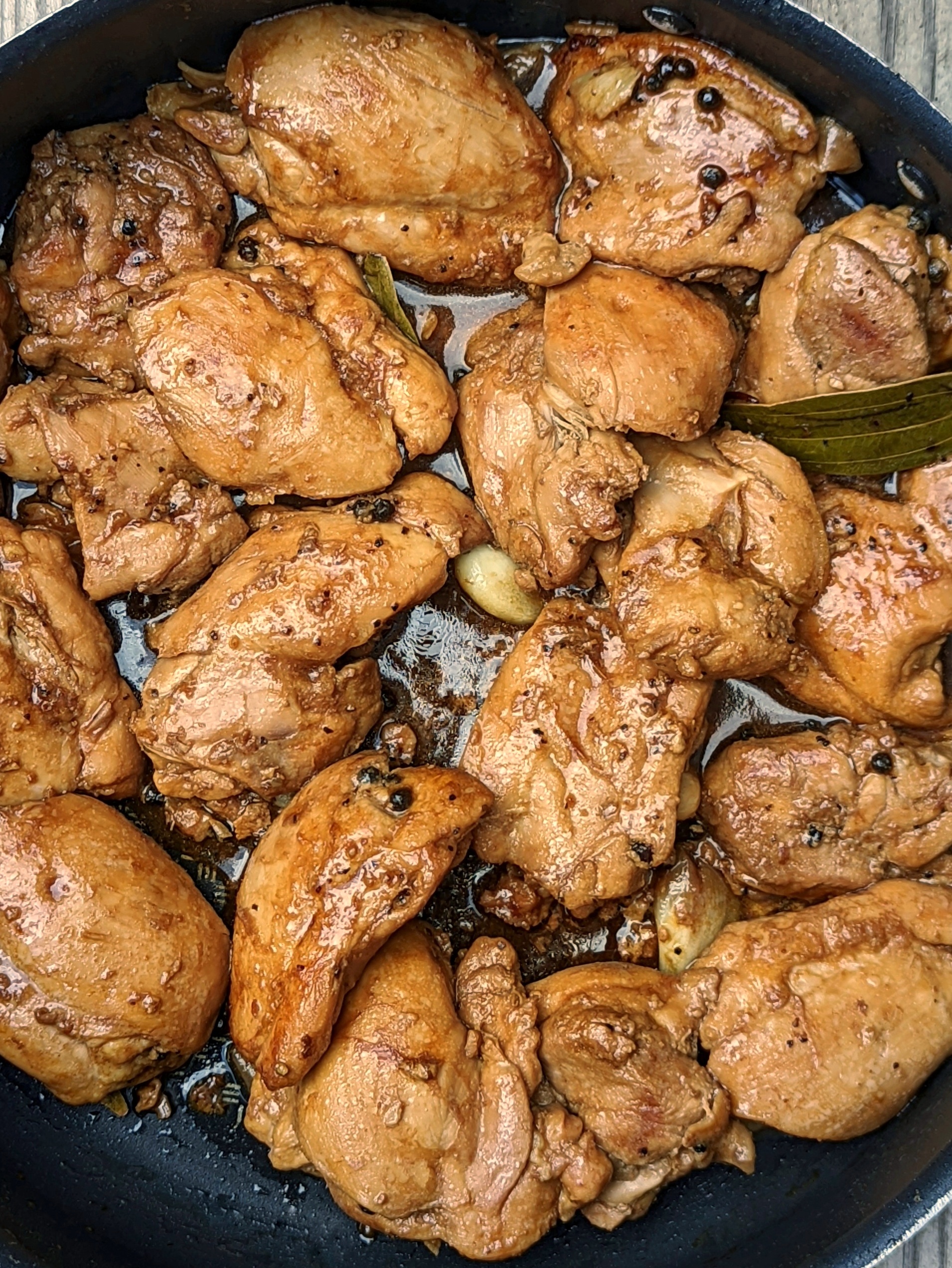 A close up of adobong manok in a pan.