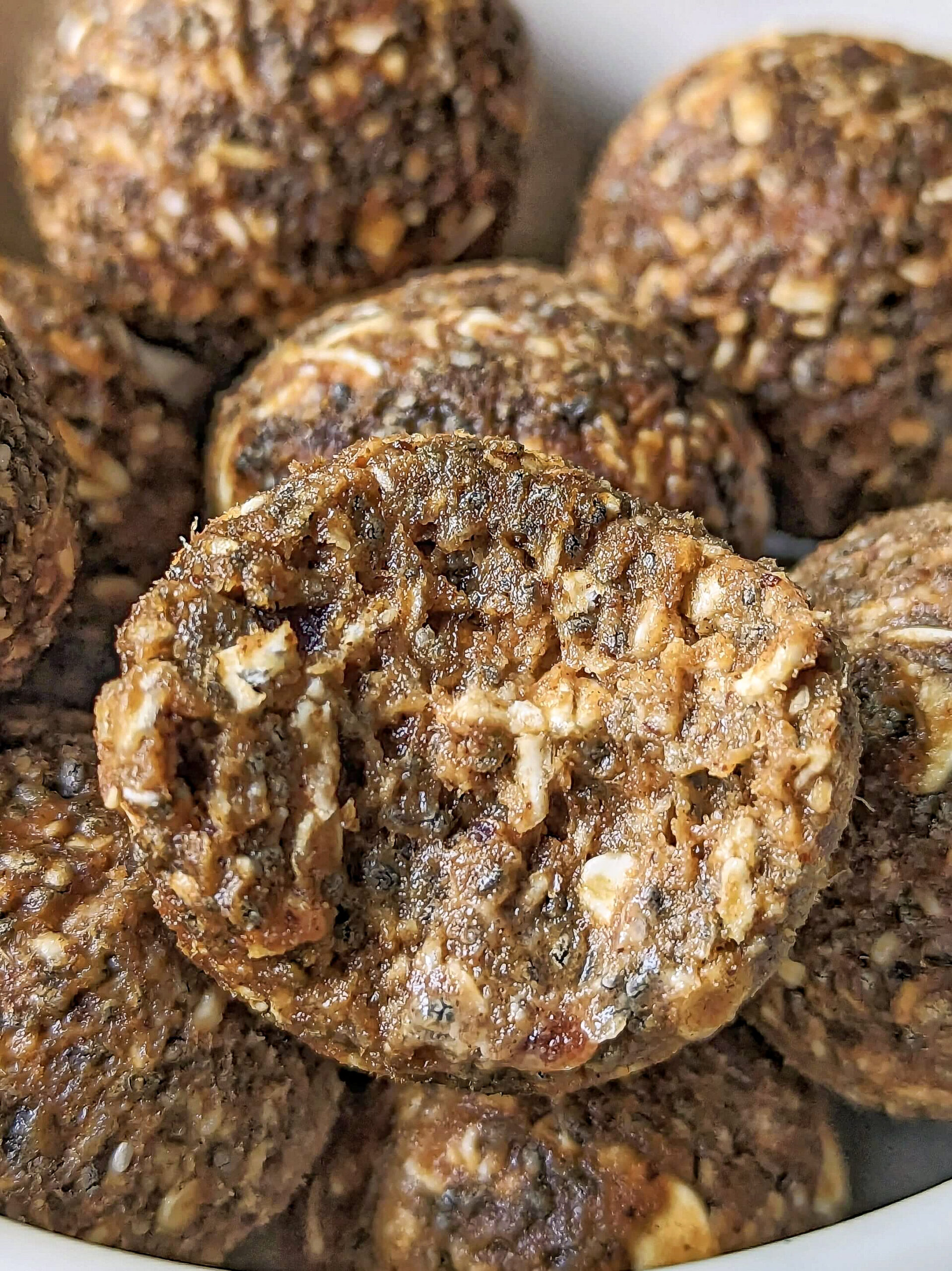 A close up of pumpkin protein balls with a bite taken out of it.
