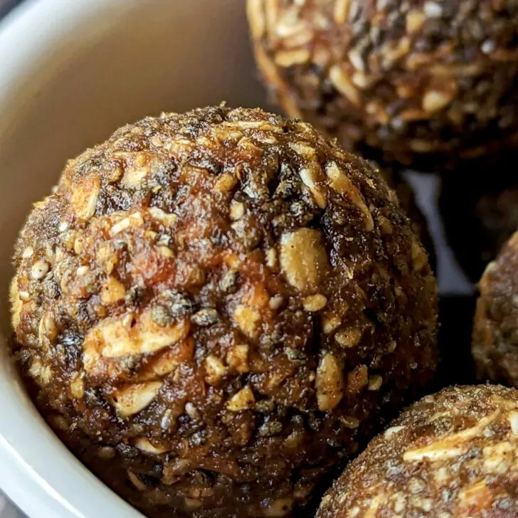 A small bowl filled with pumpkin protein balls.