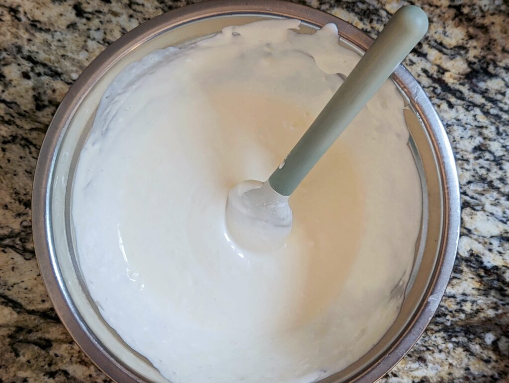 A base of sour cream, mayonnaise, and buttermilk are added to the mixing bowl.