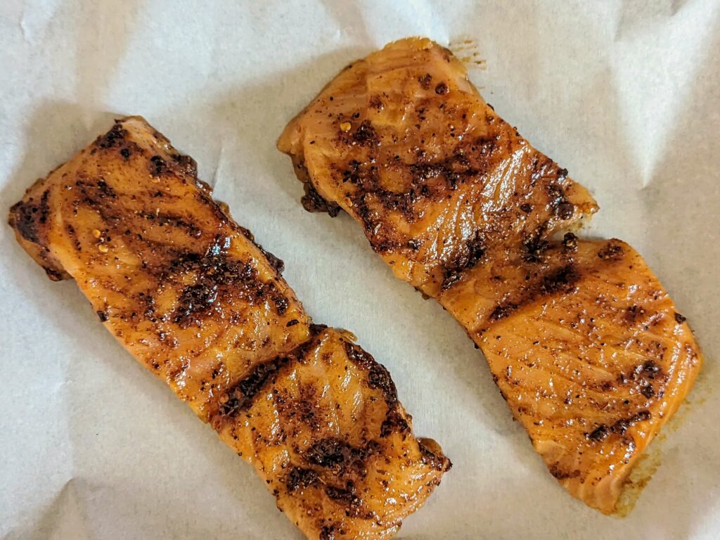 The cajun honey butter spread over the salmon fillets.