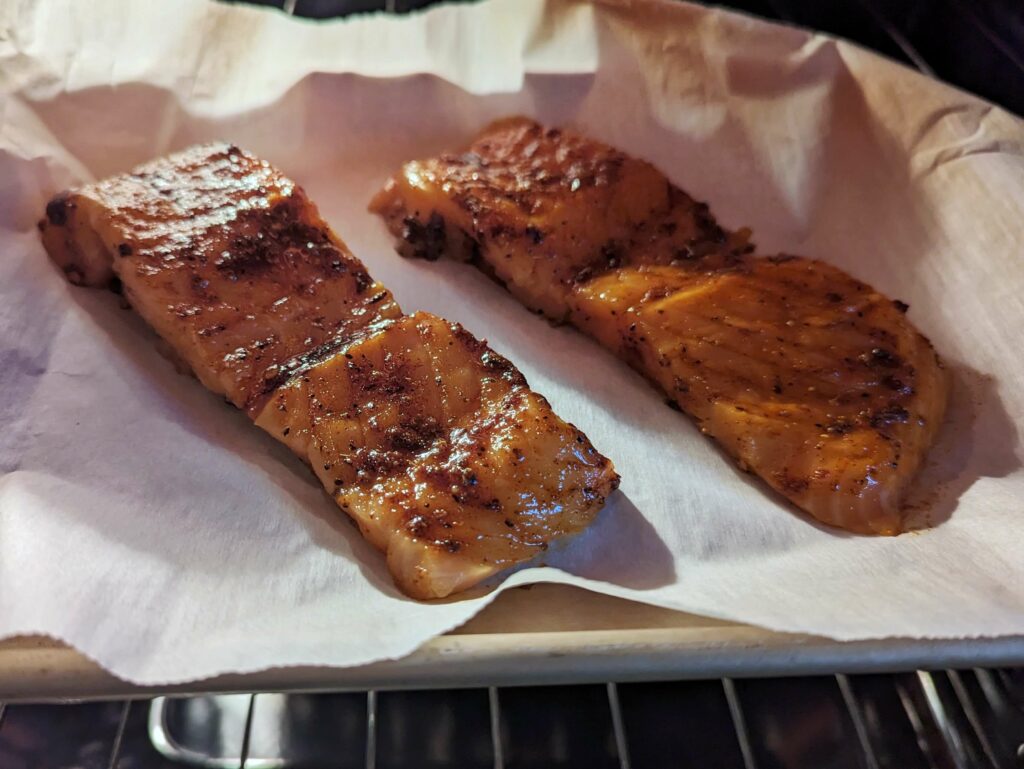 Salmon fillets broiling in the oven.