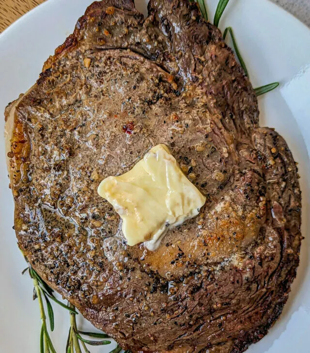 A air fryer ribeye steak on a plate.