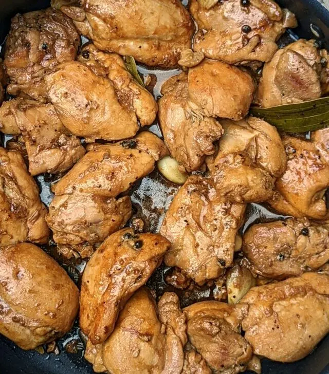 A close up of adobong manok in a pan.