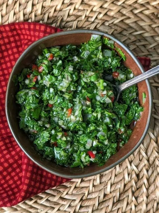A close up of a bowl of Chimichurri with Cilantro.