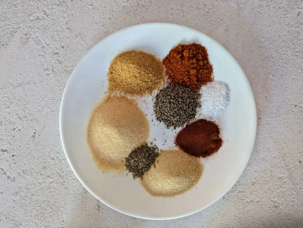The spices for the chicken rub on a plate.