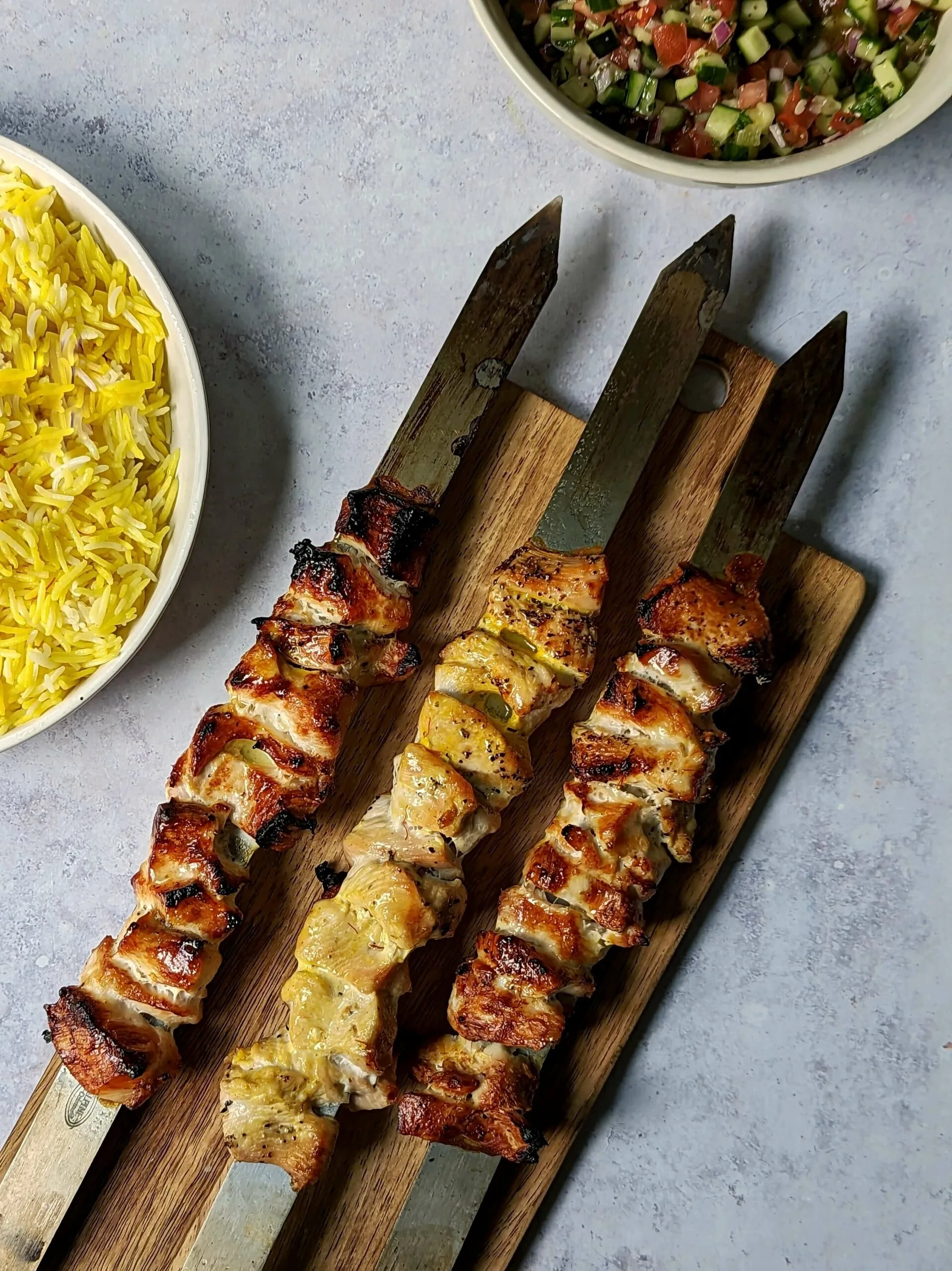 Joojeh kabobs served with saffron rice.