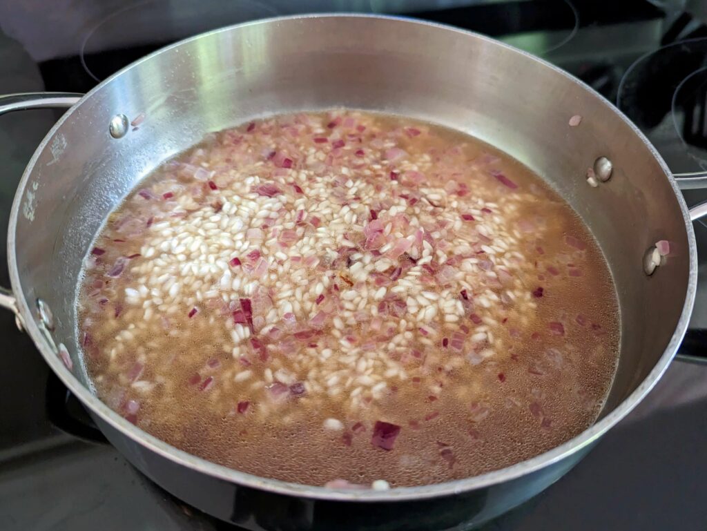 Beef stock added to the risotto little by little.