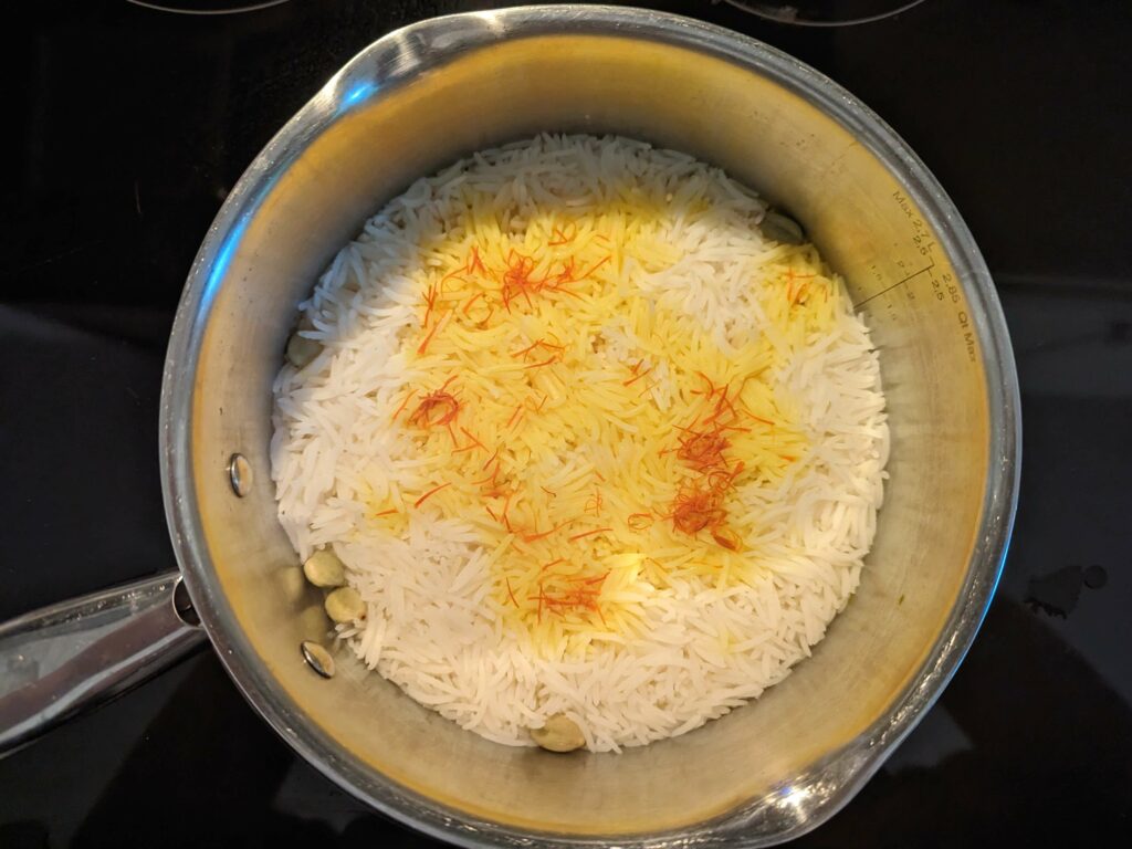 Saffron mixture poured over the cooked rice.