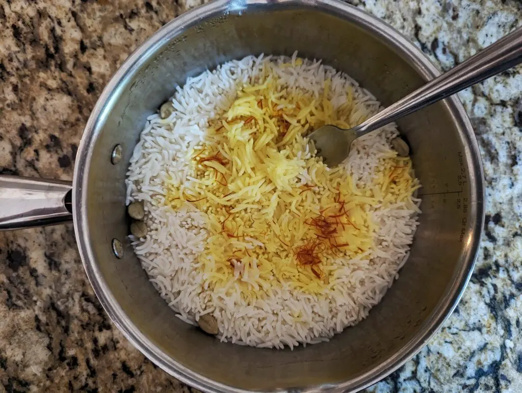A fork fluffing the rice to serve.