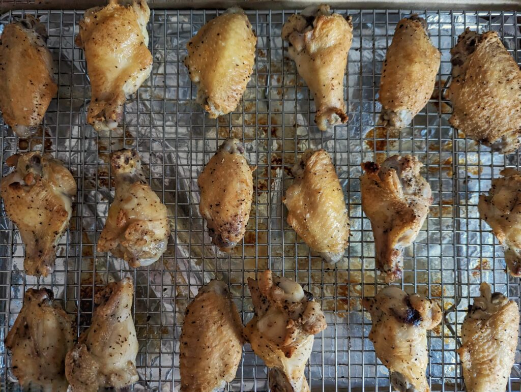 Wings resting on a wire rack after cooking.