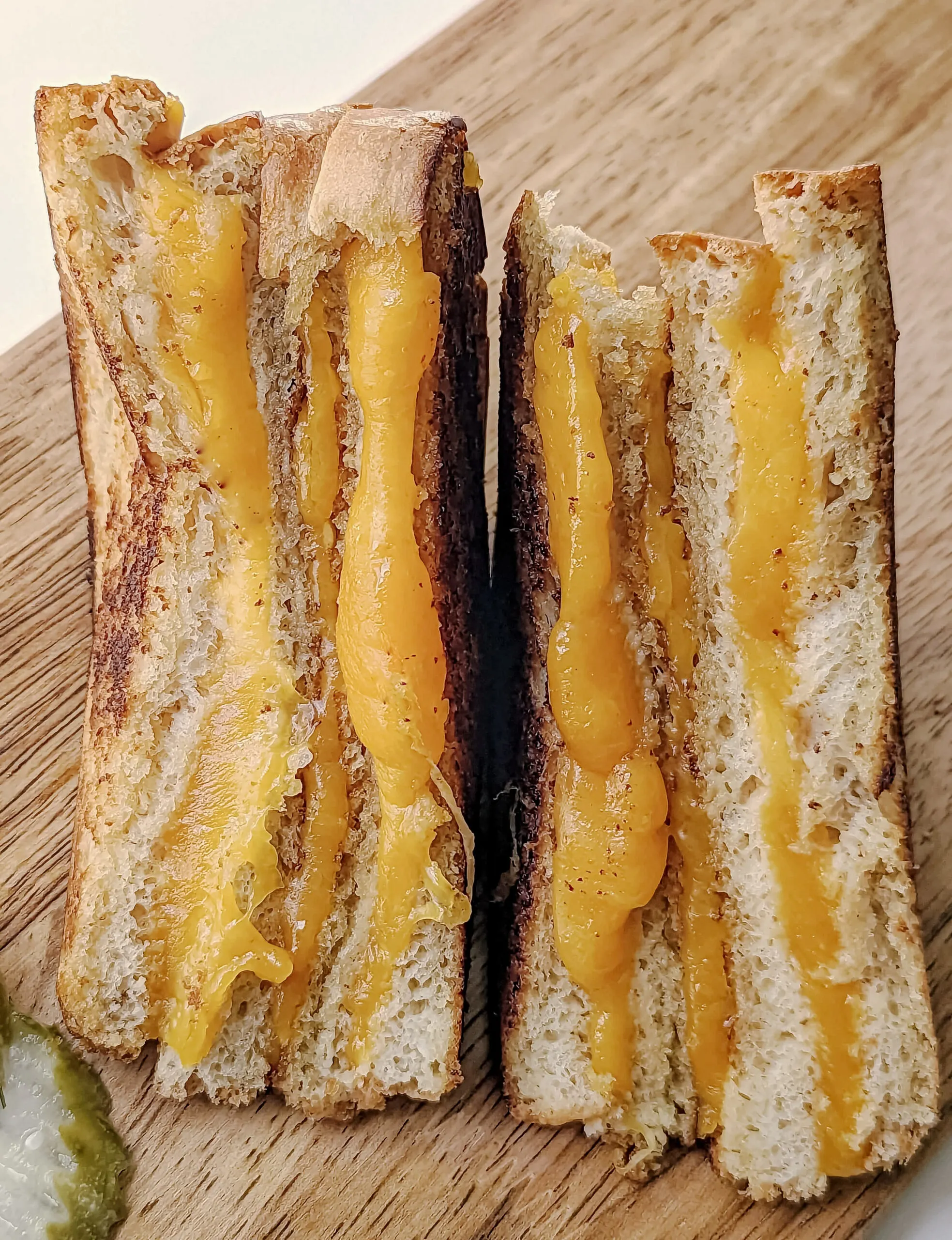 A grilled cheese sandwich cut in half.
