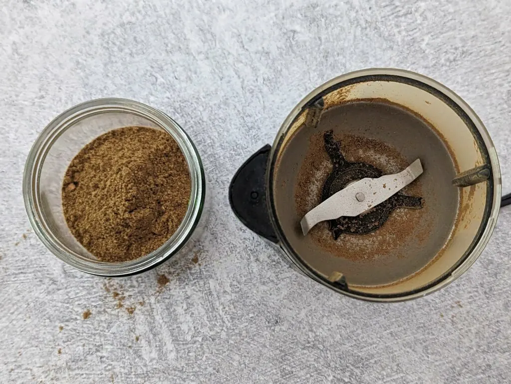 Whole spices in a spice grinder.