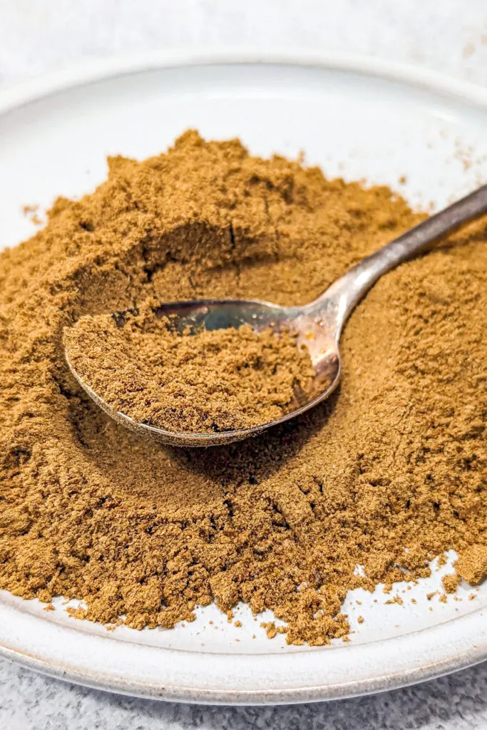 Chinese 5 Spice powder on a spoon.