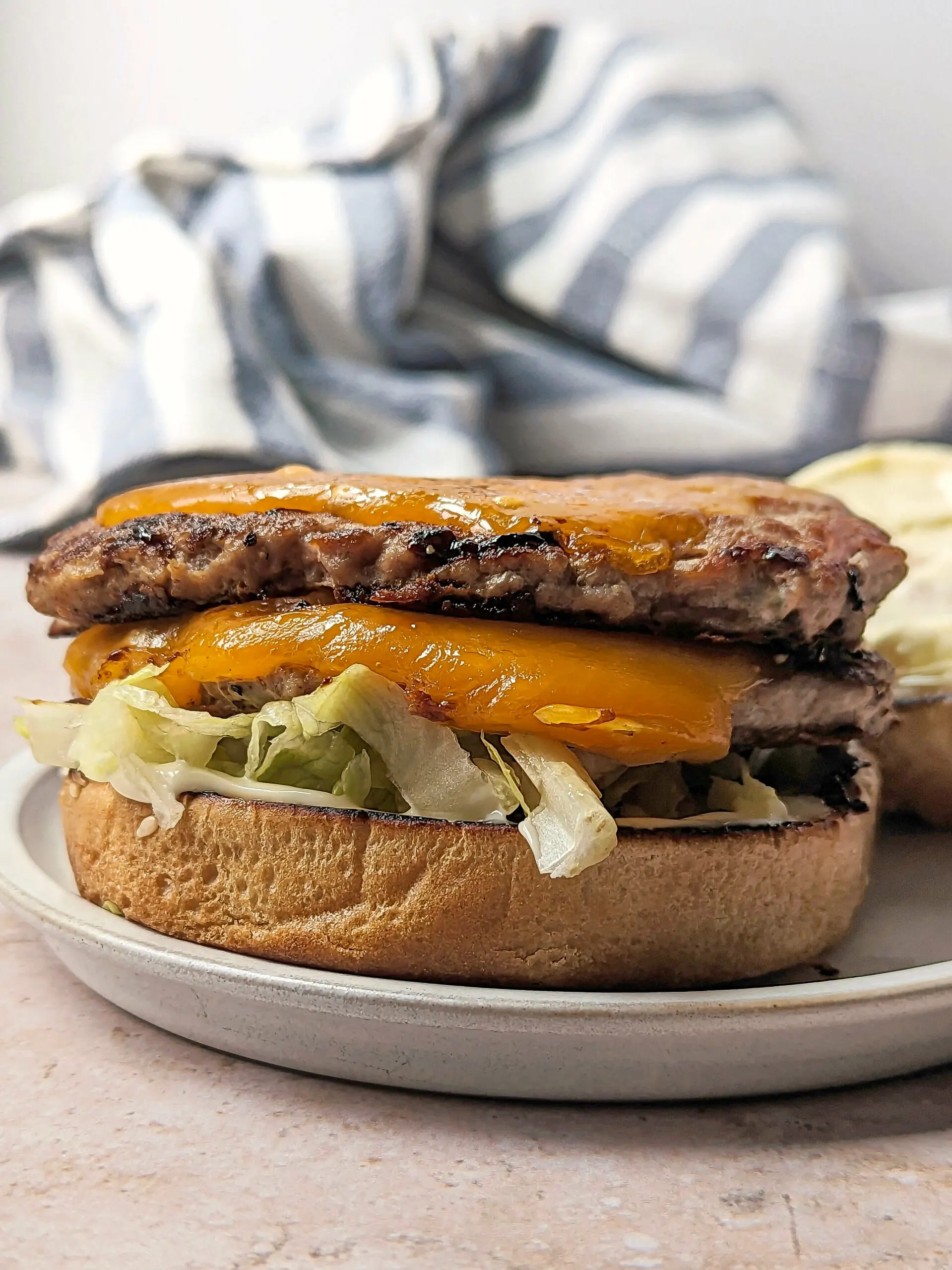 A double decker turkey smash burger without a top bun.