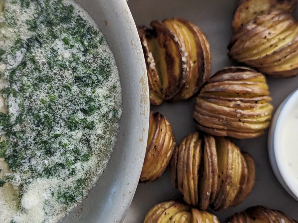Garlic butter poured over the hasselback potatoes.