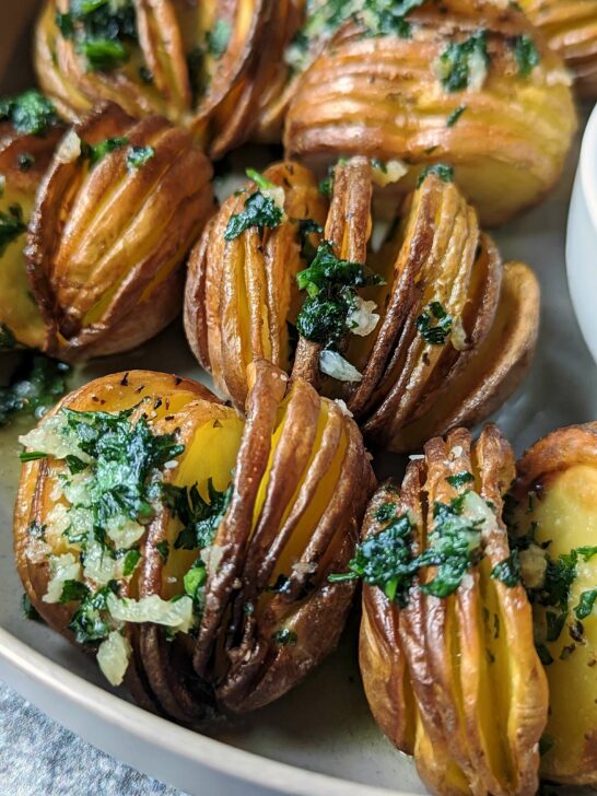 A close up of air fryer hasselback potatoes.