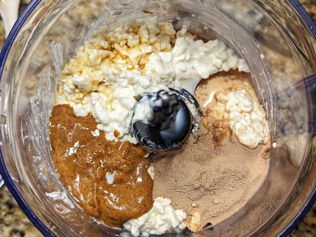 The ingredients for cottage cheese ice cream in a food processor.